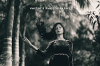 a black and white photo of a woman with her hair blowing in the wind